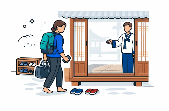 Flat or semi-flat vector illustration, clean lines, modern tech feel, 2D or light isometric, not photorealistic. A faceless traveler entering a traditional South Korean hanok stay, removing shoes neatly at the entrance, holding a small overnight bag and phone, while a calm host gestures politely inside. Deep blue and turquoise primary colors with South Korea inspired red and warm wood accents. Minimal white and light grey background with a faint hanok roofline silhouette. Calm, organized, safe, respectful atmosphere. No readable text, no watermark.